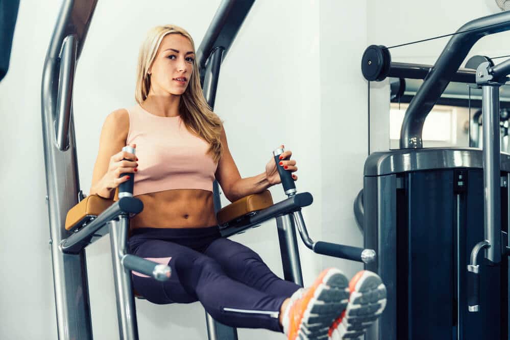 Woman working out on power tower machine - Fitness