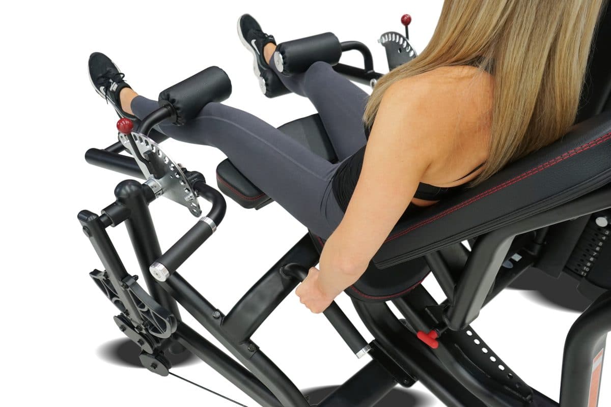 A woman is sitting on a stationary exercise bike