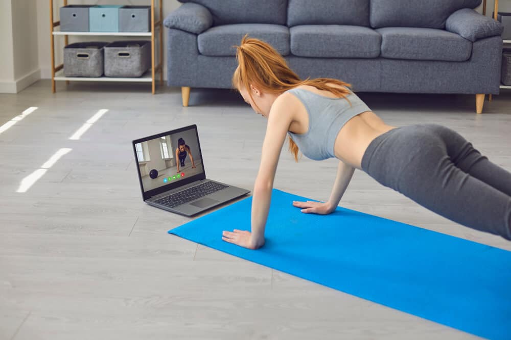 Sport home online.Young woman exercising during online training | Fitness Expo
