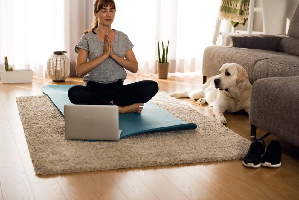 Woman Meditates with Dog| Fitness Expo Stores