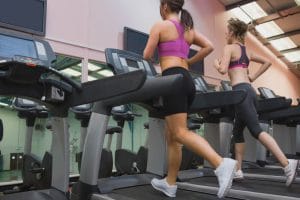 Two Women Exercising on treadmills - Fitness Expo