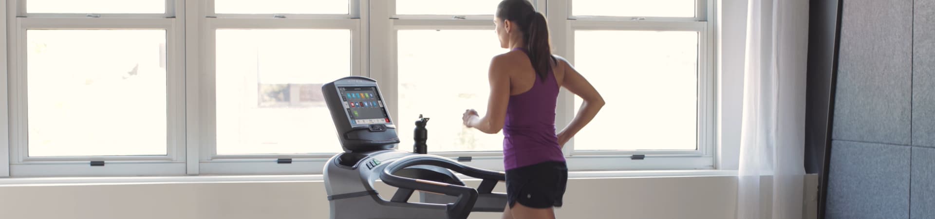 A woman is running on a treadmill