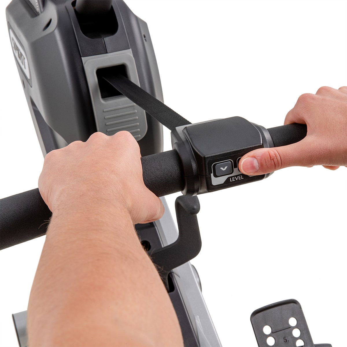 A person is holding the handle of a stationary bike.