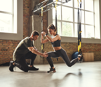 A man and a woman doing exercises in a gym