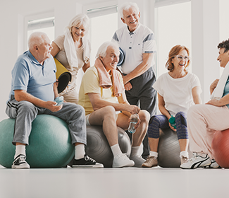 A group of older people sitting on exercise balls