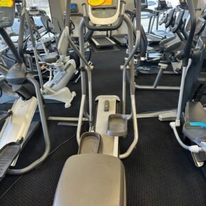 A row of exercise machines in a gym